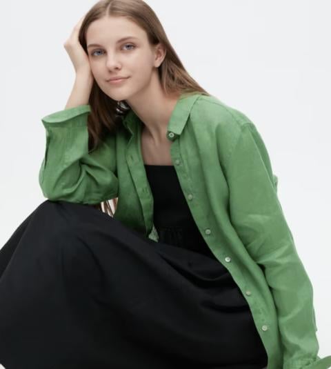 Woman wearing green linen button-down top